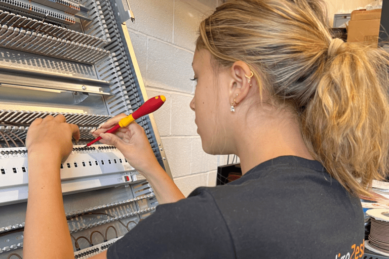 Apprentice working on lighting panel